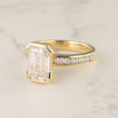 Half-bezel engagement ring setting with channel baguette side stones