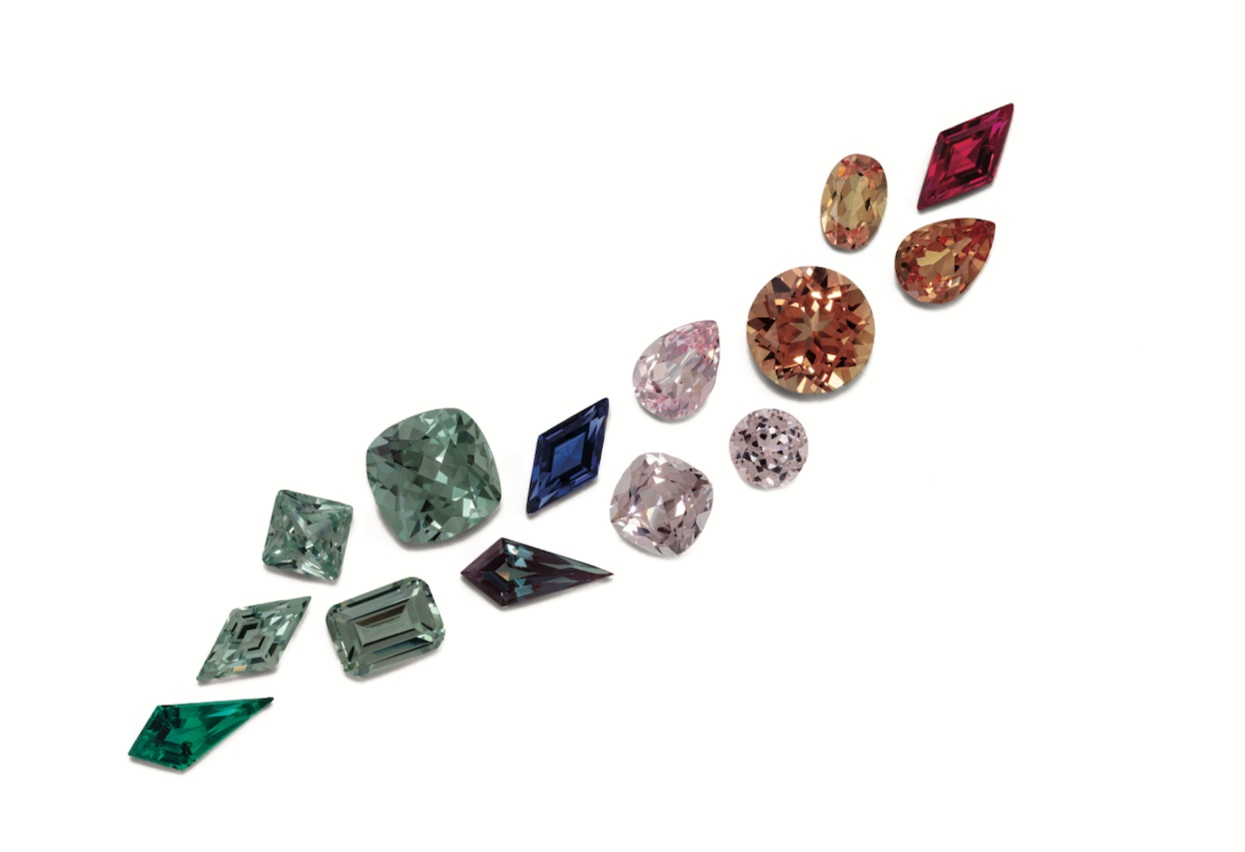 Collection of various gemstones arranged in a circular pattern on a white background