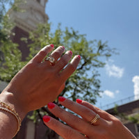 Hands showcasing a large cushion cut chunky metal engagement ring