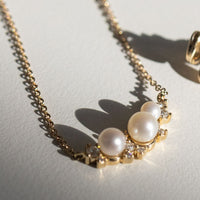 yellow gold diamond and pearl cluster necklace lifestyle