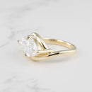 Side profile of a curvy east west bypass engagement ring