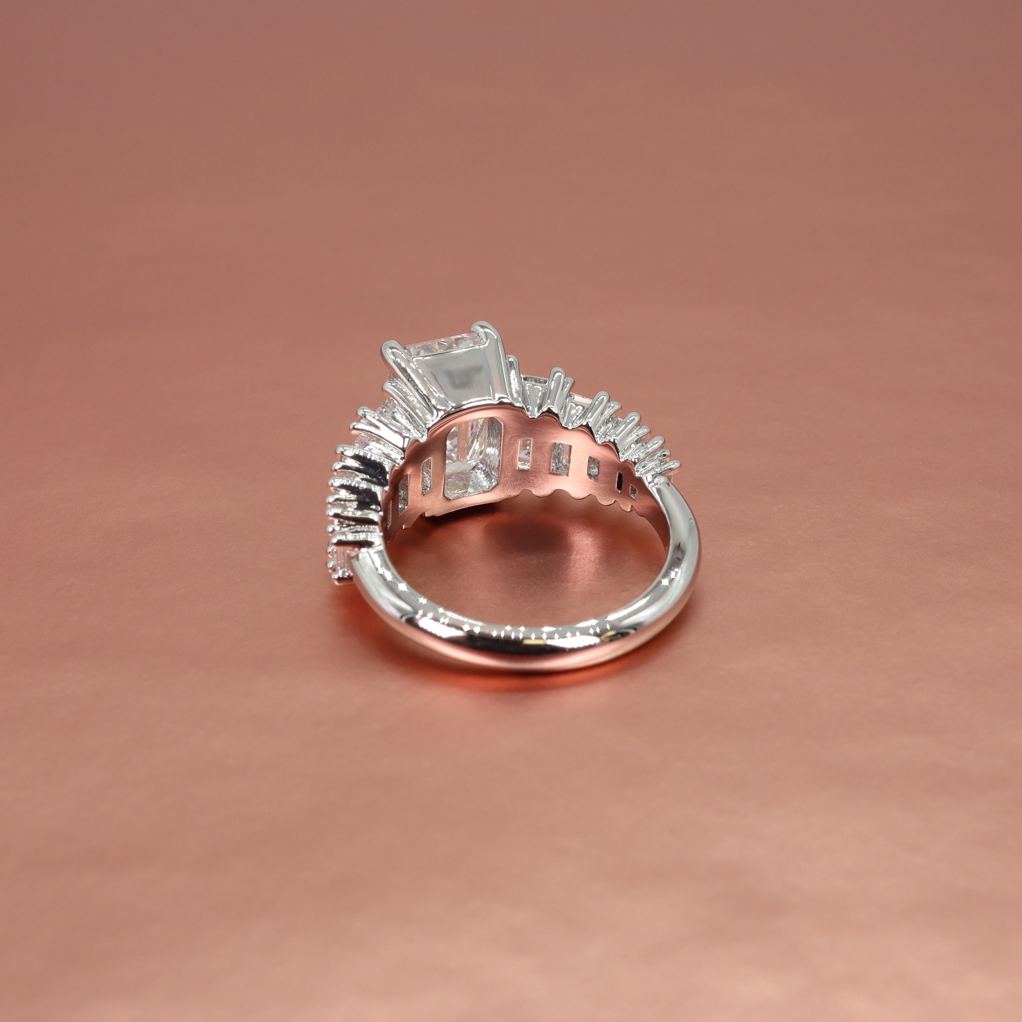 platinum ring with diamond accents on a rose gold background