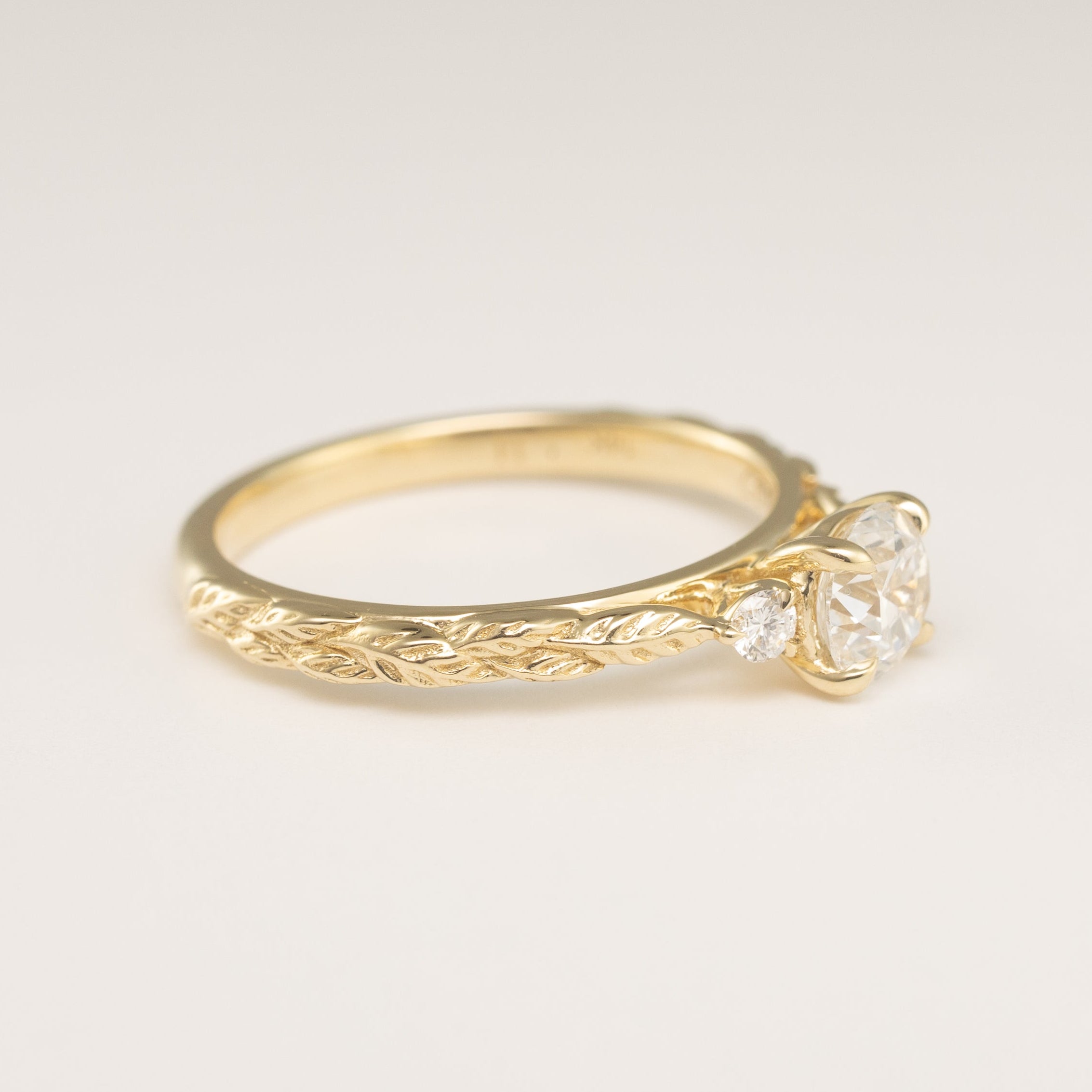 side view angle of leaf texture on an engagement ring setting