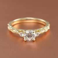 front view angle of a three stone engagement ring setting with leaf detailing