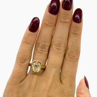 hitched yellow gold signature heirloom bezel engagement ring with natural old mine diamond on hand