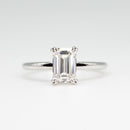 hitched white gold signature solitaire engagement ring with emerald center and double talon prongs