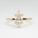 hitched yellow gold signature solitaire engagement ring with marquise center and talon prongs