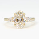 hitched yellow gold signature three-stone engagement ring with oval center and pear side stones