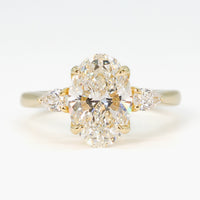 hitched yellow gold signature three-stone engagement ring with oval center and pear side stones