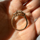 hitched yellow gold signature three-stone engagement ring with oval center and pear side stones side profile