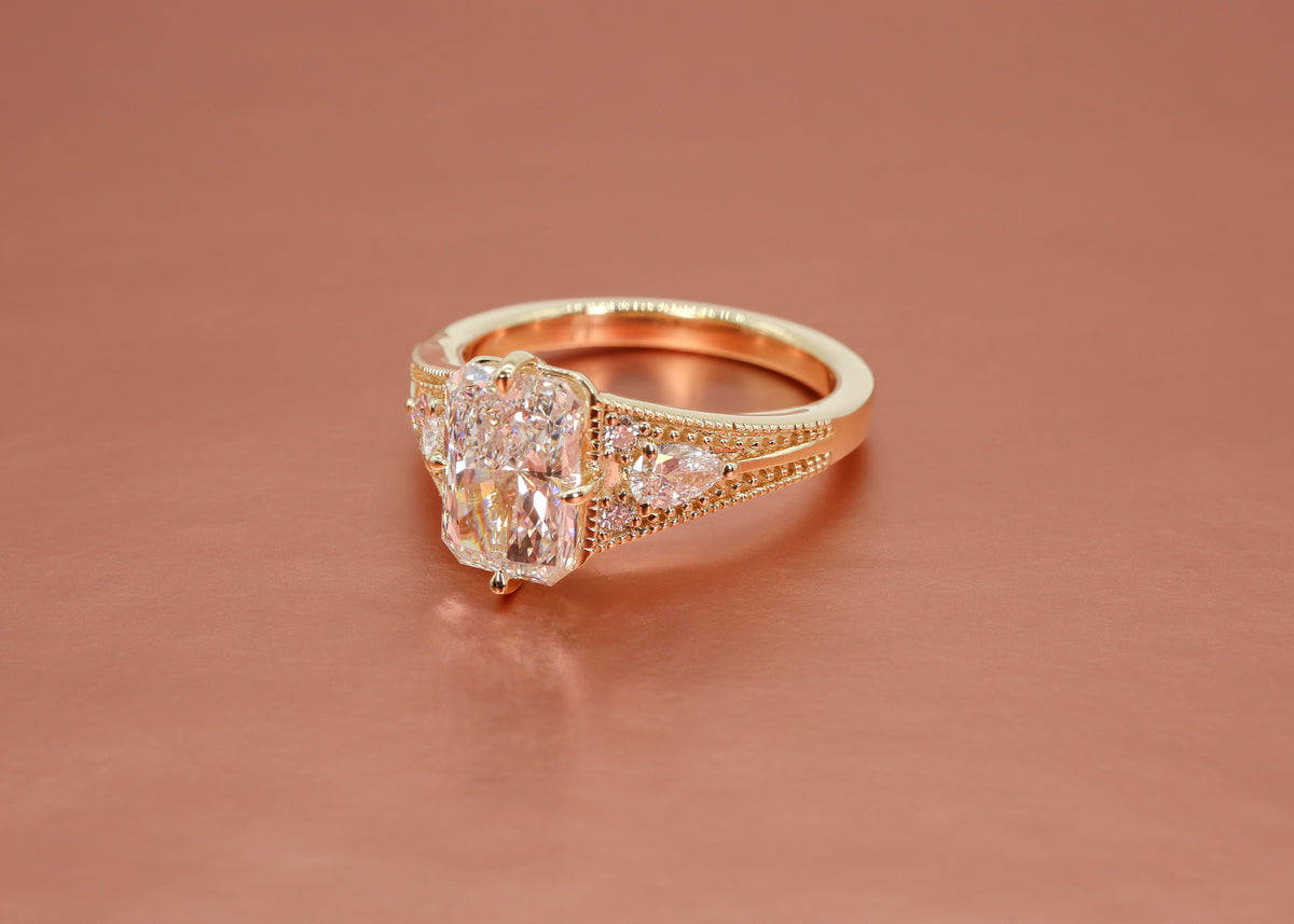 yellow gold engagement ring with a radiant-cut diamond on a rose gold background