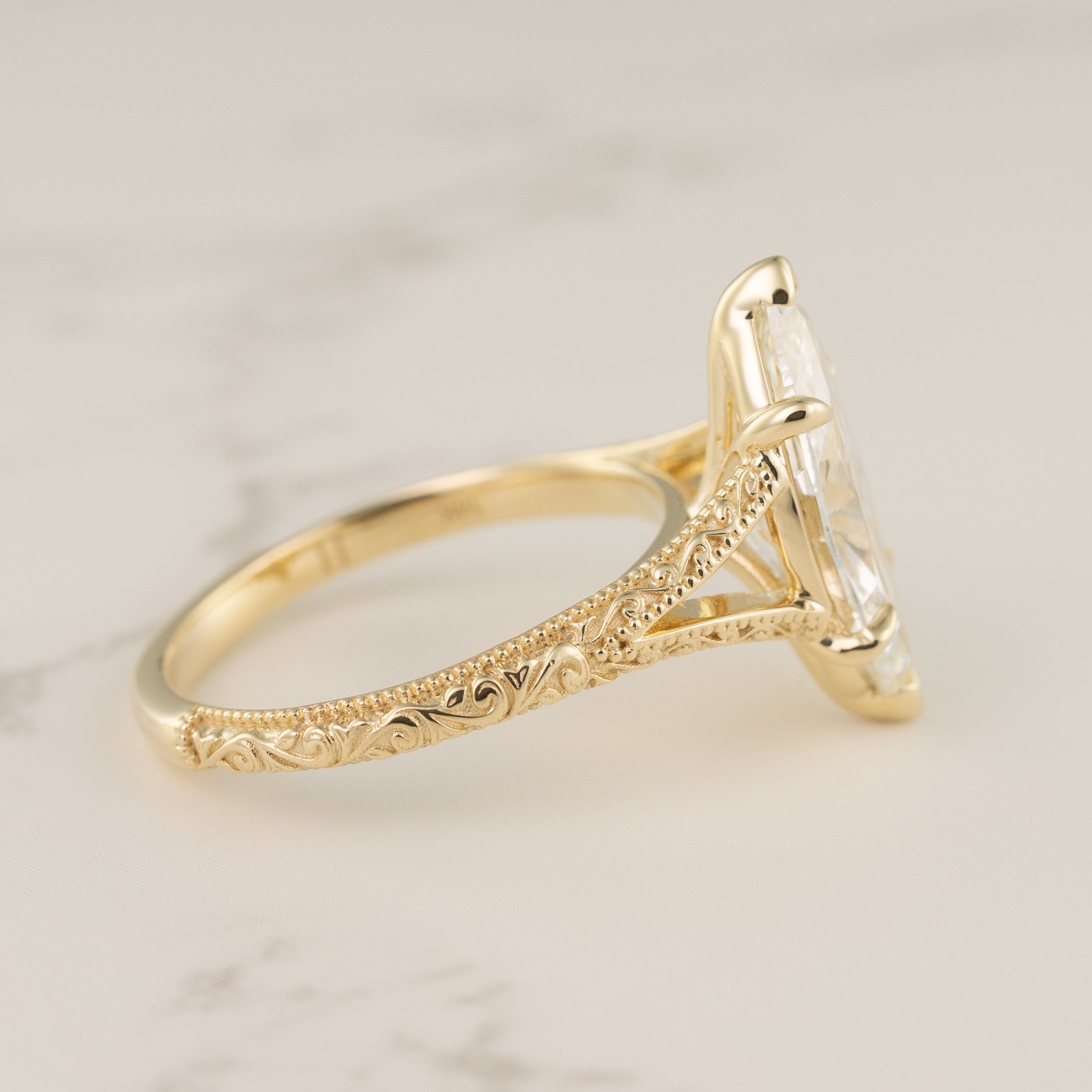 side view of a split-shank filigree and milgrain engagement ring