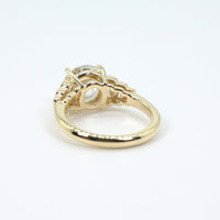 Gold vintage-inspired ring with intricate design on a white background
