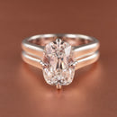 An engagement ring with a bold double band setting and compass set prongs