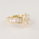 Tapered engagement ring with channel-set lab-grown baguette diamonds on a white background