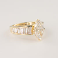 Tapered engagement ring with channel-set lab-grown baguette diamonds on a white background