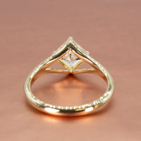 Basket view of a yellow gold split shank engagement ring with a kite set asscher cut diamond