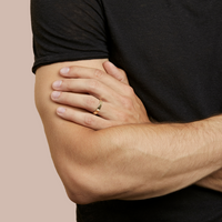 hitched men's yellow gold flat wedding band in a 4mm width on model